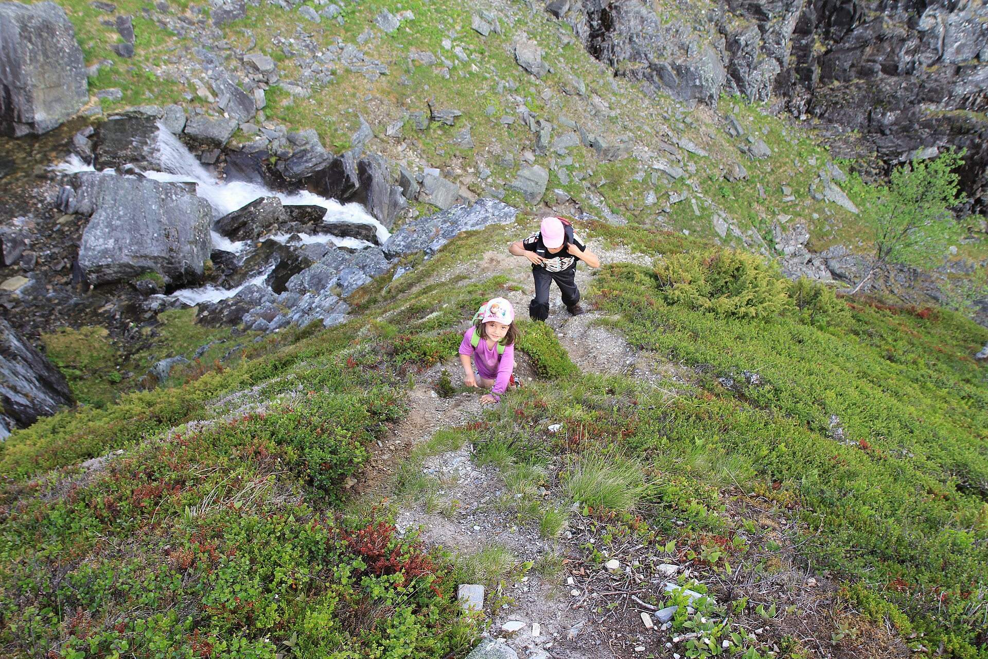 A trekker climbing a steep mountain trail