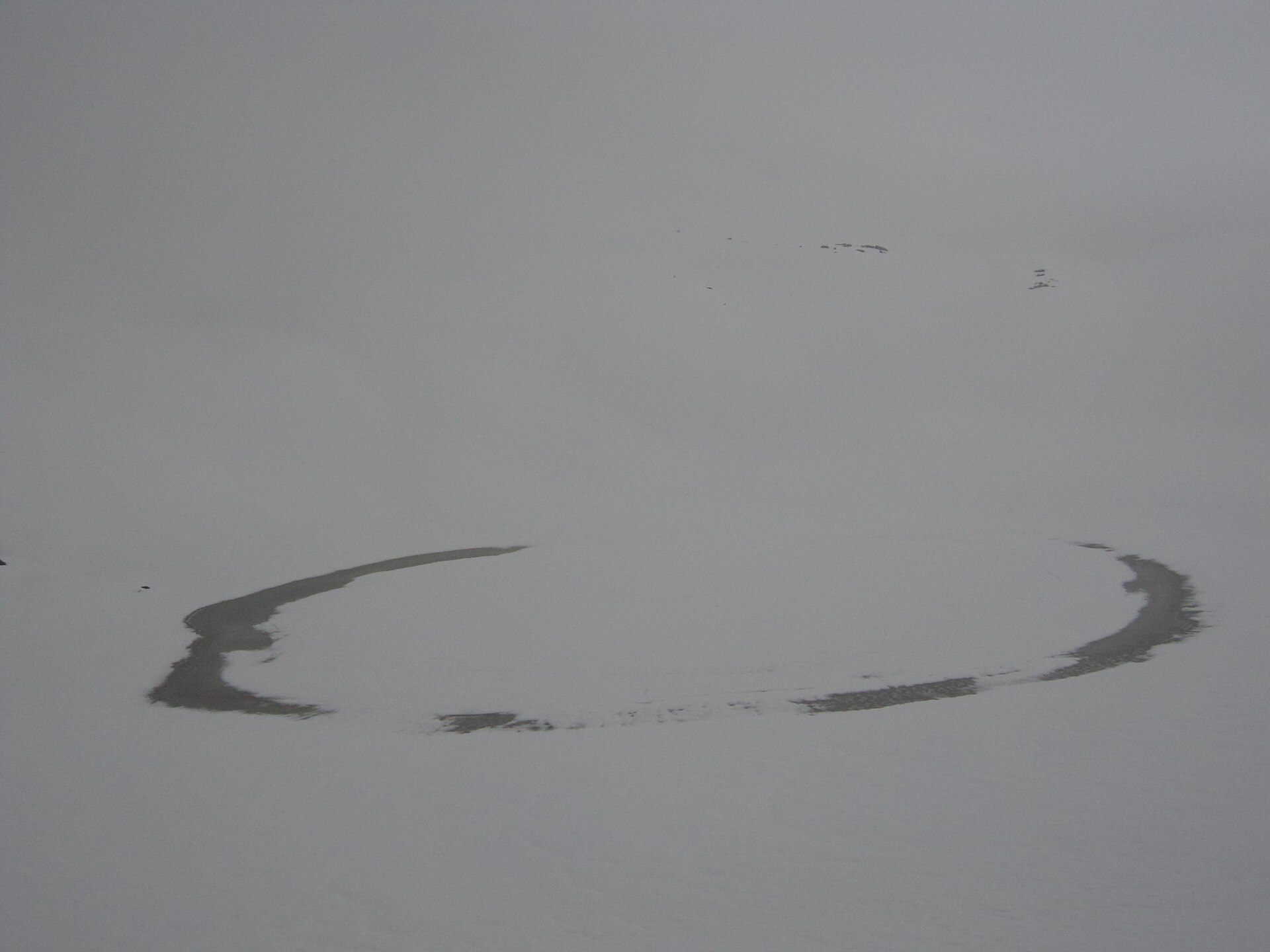 Bhrigu Lake surrounded by open meadows